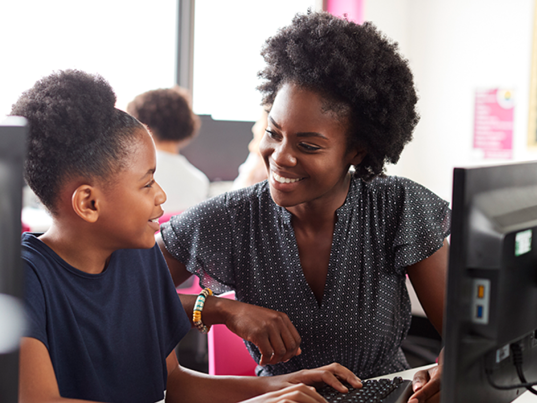 Woman teaching child to code