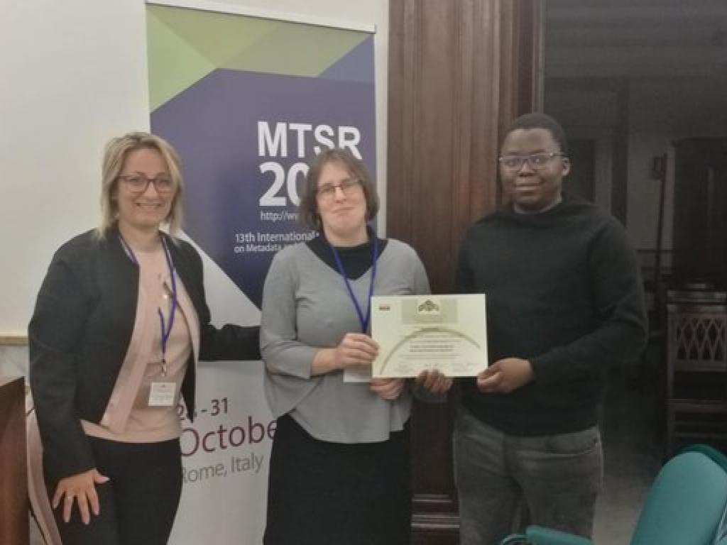 Associate Professor Maria Keet (centre) with Zola Mahlaza (tight) at MTSR 2019. Photo: MTSR